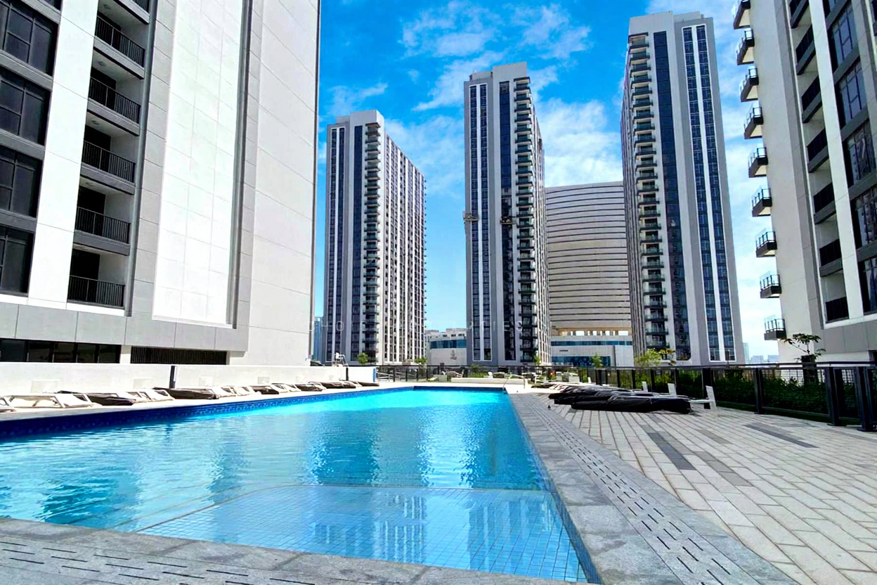 Contemporary residential towers at Shams Abu Dhabi including The Bridges and Meera with landscaped parks and marina views.